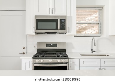 Small All White Kitchen With Shaker Style Cabinets And Clear Countertops