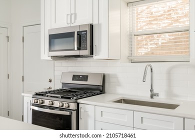 Small All White Kitchen With Shaker Style Cabinets And Clear Countertops