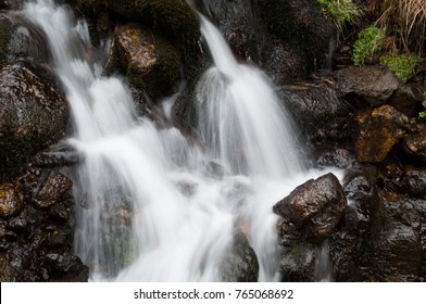 A small alpine stream rushing down the side of a mountain (long exposure)