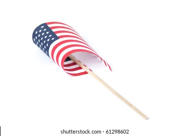 Small American Flag On Carrying Handle, Partially Curled Up. Shot On A White Background.