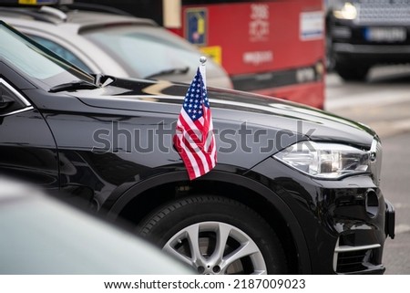 Small American Flag with stars and stripes on the luxury black car. Diplomatic car of USA. Officials of US embassy in Serbia, meeting of country ambassadors.