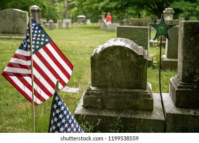 Small American Flags And Headstones At Cemetary In Boston MA