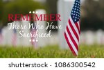 Small American flags and headstones at National cemetary- Memorial Day display - with copy