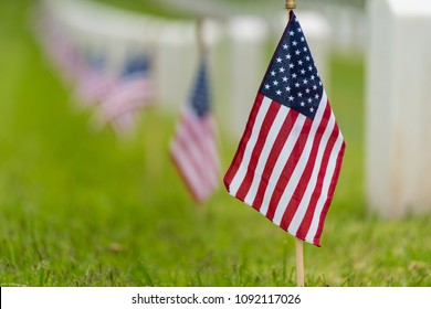 Small American flags and headstones at National cemetary- Memorial Day display