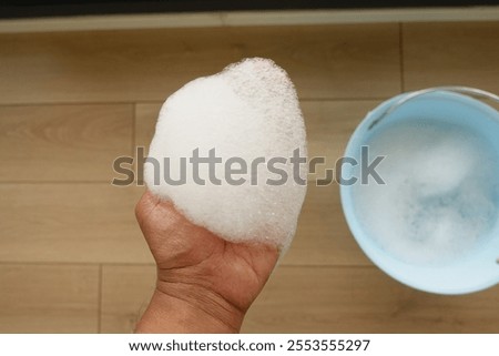 A small amount of soapy foam was collected in a bucket for household cleaning and hygiene