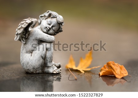 Small angel statue as grave decoration