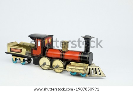A small antique tinplate floor locomotive by Hess of Germany on a plain white background.