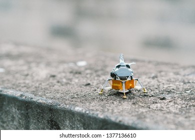 Small Apollo Lunar Module toy landing on corrosion concrete surface. - Powered by Shutterstock