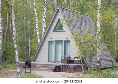 a small a-shaped house in the forest