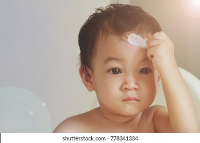 A Small Asian Toddler Boy With A Bruised And Bandage On Face.1 Year Old Boy Has Accident,Accidental Injuries Are A Major Health Problem In Children Over One Year Of Age. Common Danger At Home.