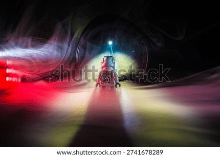 Small astronaut facing distant light in smoky abstract scene