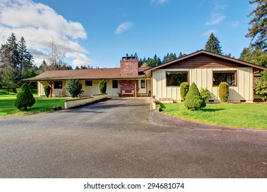 Small Authentic Home With Brown Trim And Grass.