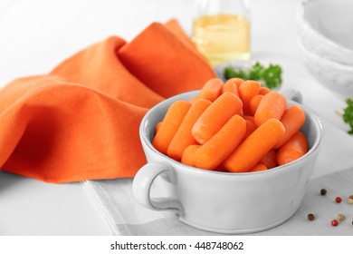 Small Baby Carrots In Soup Plate On Napkin