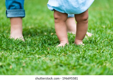 Small Baby Feet On Green Grass