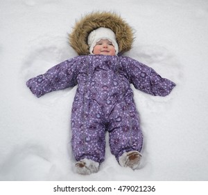 Small Baby Girl Lying In Snow Winter Little Angel