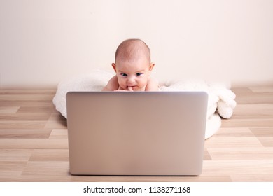 Small baby infant working playing learning on the laptop wireless serious face expression funny thinking face - Powered by Shutterstock