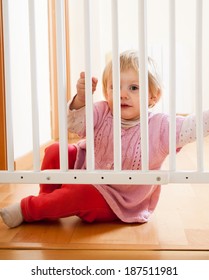 Small Baby  Near Safety Gate Of  Stairs