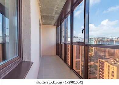 Small balcony interior in modern apartment building beige tiled floors and black window frames - Shutterstock ID 1729810342