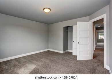 Small Basement Room Interior With Grey Walls And White Trim. The Room With Walk In Closet.