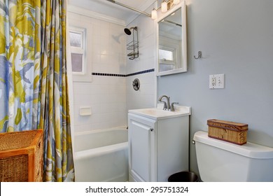 Small Bathroom With Colorful Shower Curtain, And Lovely Blue Walls.