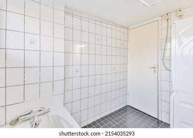 A Small Bathroom Combined With A Laundry Room In Black And White Style In A Modern Apartment