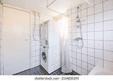 A Small Bathroom Combined With A Laundry Room In Black And White Style In A Modern Apartment