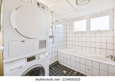 A Small Bathroom Combined With A Laundry Room In Black And White Style In A Modern Apartment