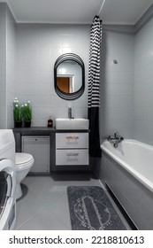 Small bathroom in gray finishing with washingmachine