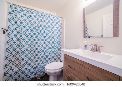 Small Bathroom With Patterned Shower Curtain In House