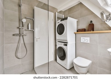 a small bathroom with a washer and dryer in the corner next to an open shower stall on the wall
