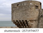 Small battlement on stepped corbels at the 1564 built Jardin du Cavalier Garden northwest corner, pointing to the 1652 built Tour Bidouane Tower at the Saint-Malo rampart NW extreme. Brittany-France.