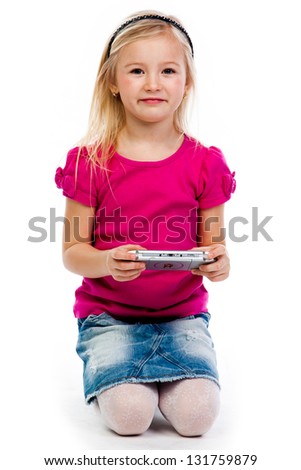 Small and beautiful girl playing psp