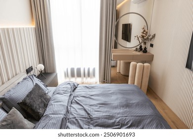 A small bedroom interior with a large bed next tothe big window in a modern house - Powered by Shutterstock