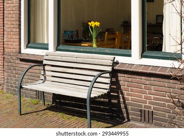 small bench in front of a window