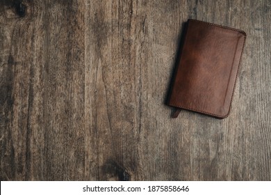 Small Bible On A Wooden Texture. Bible Study Desk