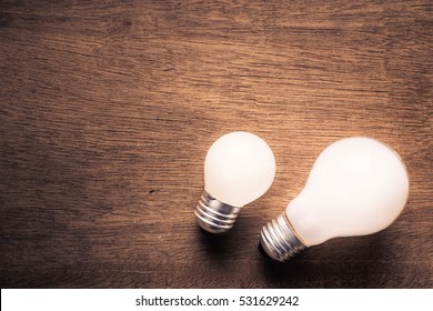 Small And Big Light Bulb, Small And Medium Sized Business, Coaching, Training, Or Other Comparison Concept