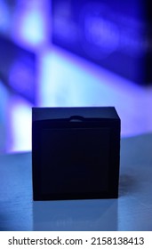 Small Black Box For Gift On Blue And White Background
