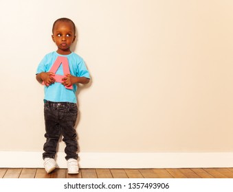 Small Black Boy Hold A Letter With Calm Expression