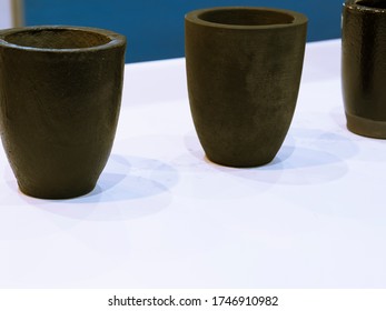 The Small Black Ceramic Crucible For Transfer Molten Metal Into Mold ; Industrial Engineering Equipment Background