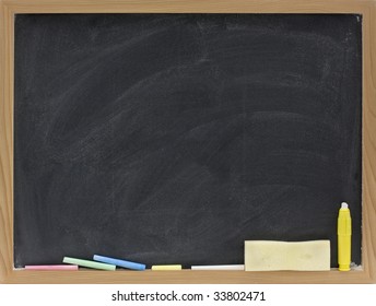 small blank blackboard in wooden frame with pieces of chalk and eraser sponge