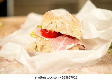 A Small BLT Sandwich On Paper Wrap