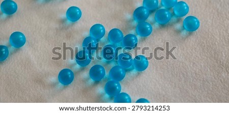 Small blue 3D round particles left undisturbed on the countertop
