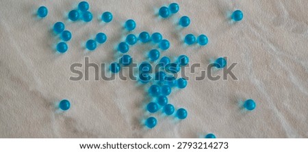 Small blue 3D round particles left undisturbed on the countertop