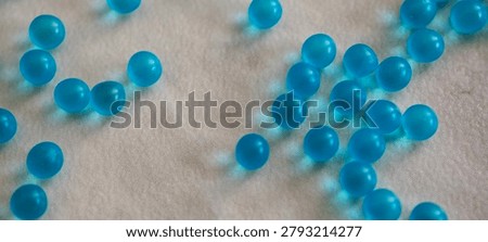 Small blue 3D round particles left undisturbed on the countertop
