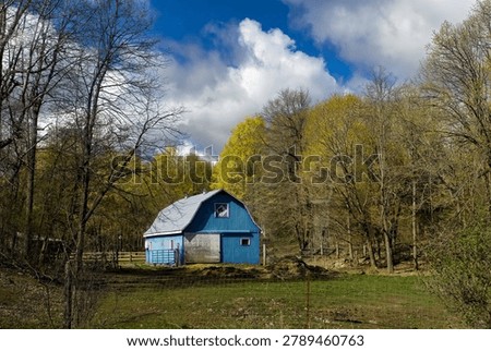 A Small Blue Barn in Early Spring