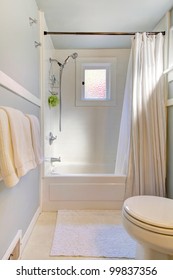 Small Blue Bathroom With Light Grey Blue And Shower Curtain.