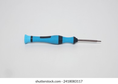 A small blue cell phone screwdriver with flat lay made of plastic on a white background                        
