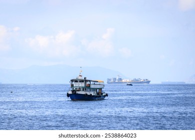 Small Boat and Cargo Ship on a Calm Sea - Powered by Shutterstock