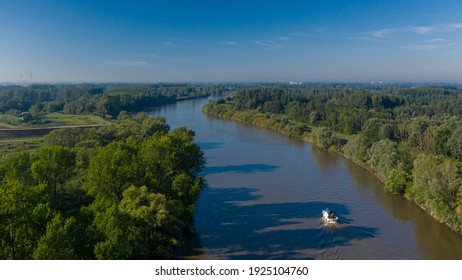 Small Boat Cruising On Scheldt River, In East Flanders, Belgium