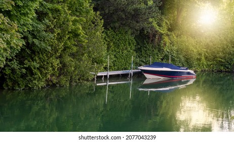 Small boat in the lake under evening sunlight in rural Michigan